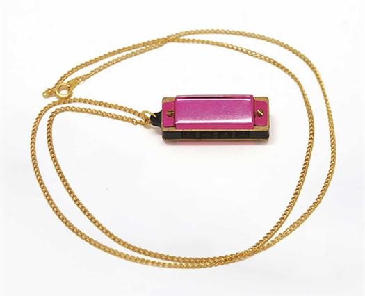 5 hole pink harmonica with a necklace